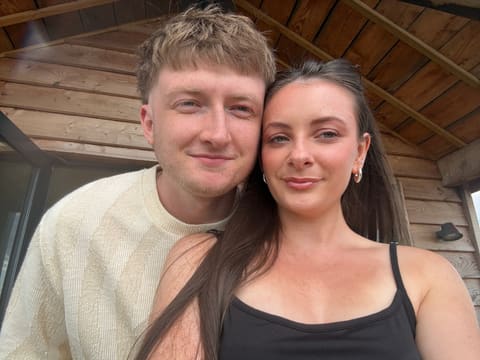 Tallulah and Thomas outside a wooden cabin