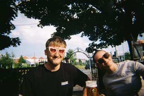 Tallulah and Thomas out for a drink, one in heart-shaped sunglasses